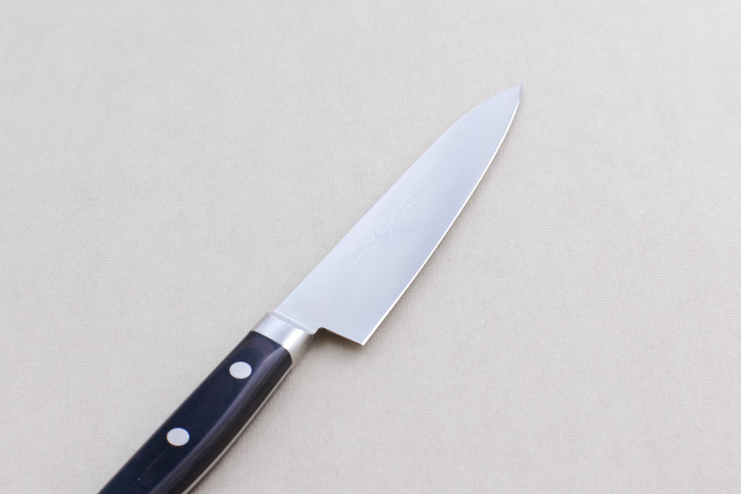 Yoshihiro 1141 8A stainless steel petty 120 with a pakka handle