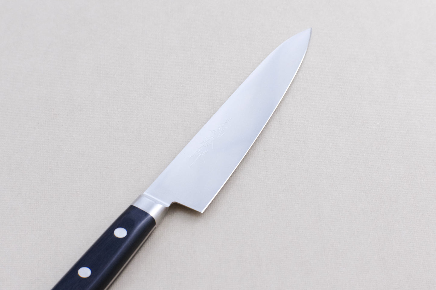 Yoshihiro 1141 8A stainless steel petty 150 with a pakka handle