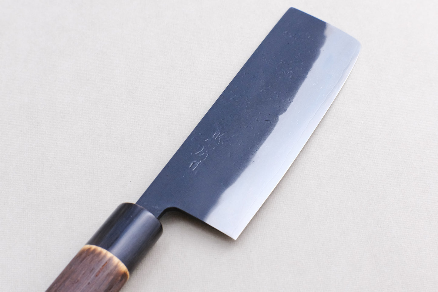 Tadafusa black nashiji SLD nakiri with a burned chestnut oval handle and buffalo horn collar 165 mm