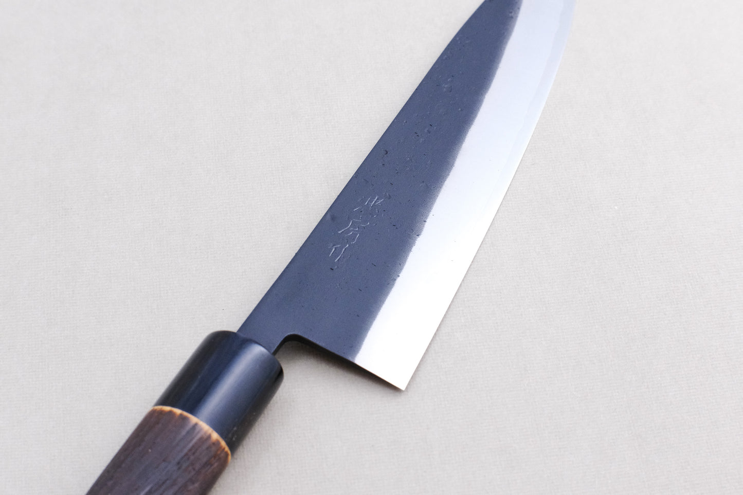 Tadafusa black nashiji SLD gyuto with a burned chestnut oval handle and buffalo horn collar 210 mm