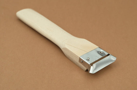 Stainless steel peeler with magnolia wooden handle