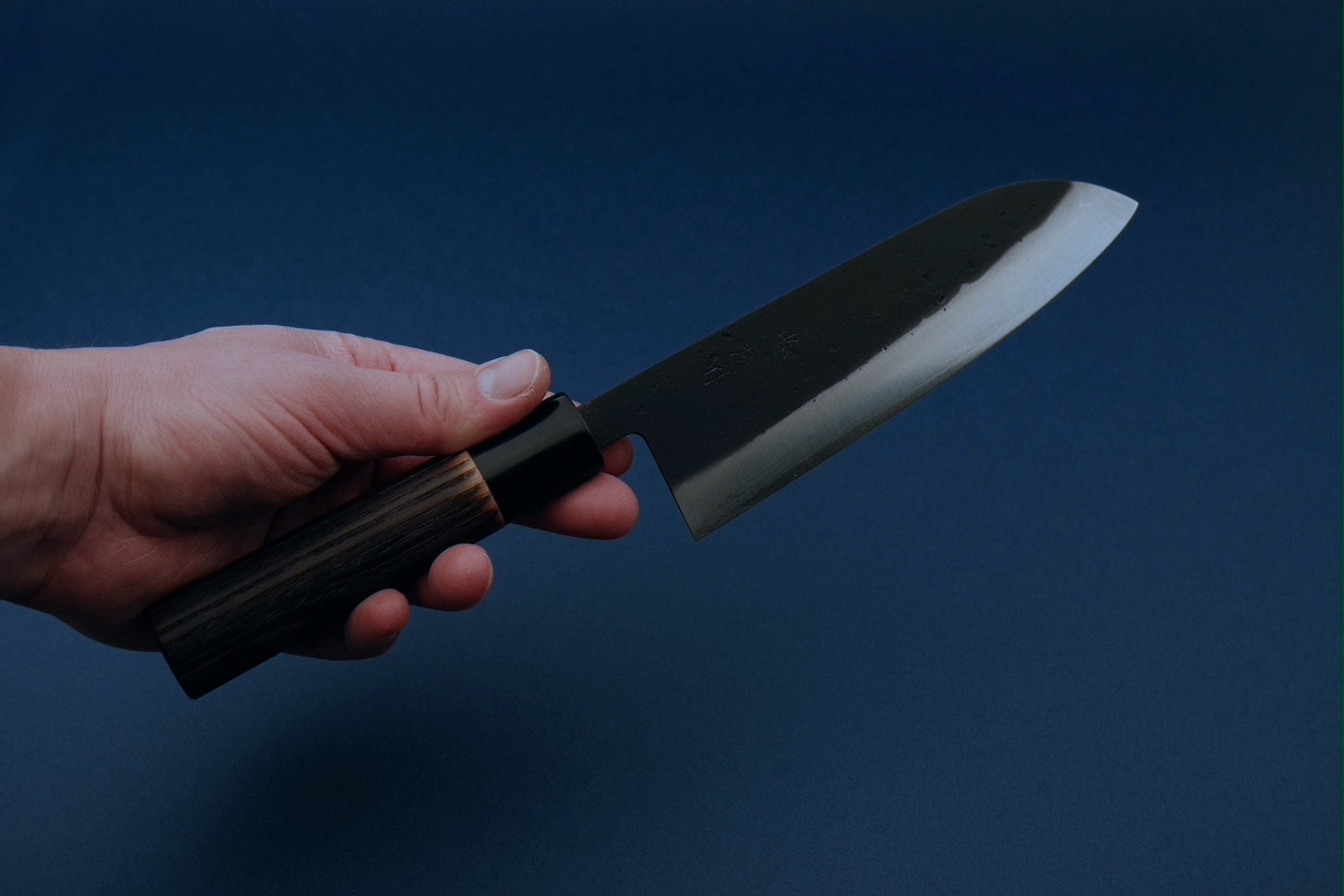 Tadafusa black nashiji SLD santoku with a burned chestnut oval handle and buffalo horn collar 165 mm