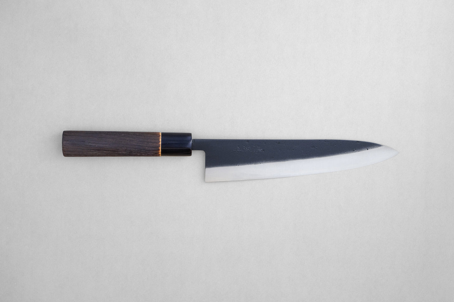 Tadafusa black nashiji SLD gyuto with a burned chestnut oval handle and buffalo horn collar 210 mm