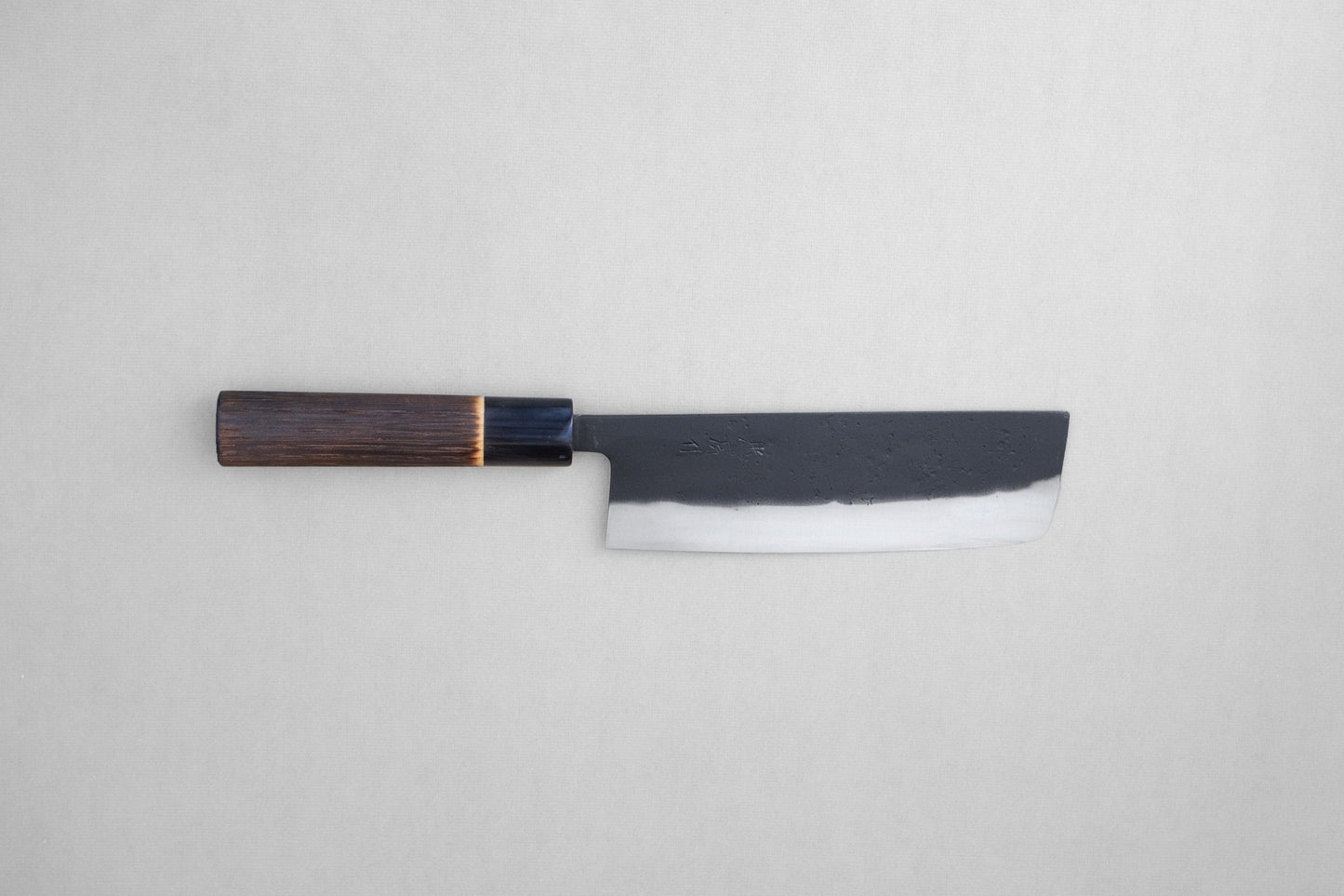 Tadafusa black nashiji SLD nakiri with a burned chestnut oval handle and buffalo horn collar 165 mm