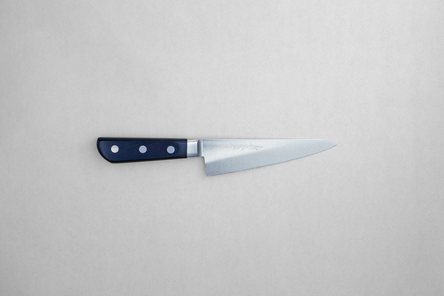 Yoshihiro 1141 8A stainless steel honesuki 150 with a pakka handle