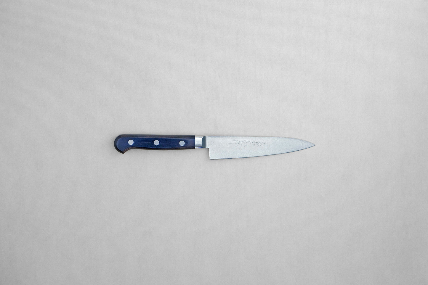 Yoshihiro 1141 8A stainless steel petty 120 with a pakka handle